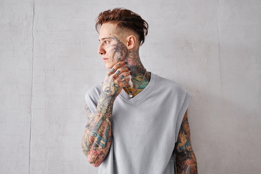 a man with tattoos on his arms and shoulder