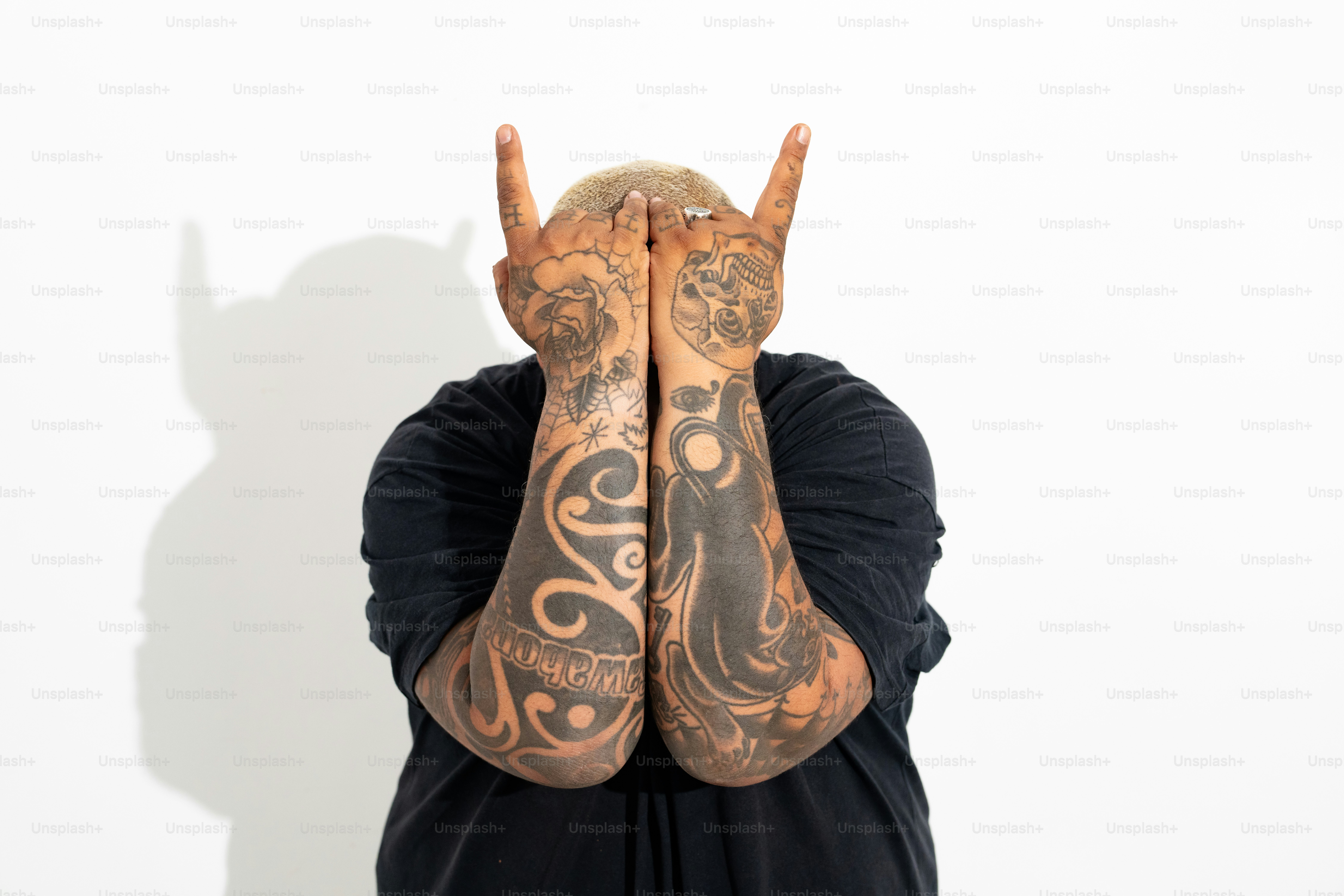 a man covering his face with his hands