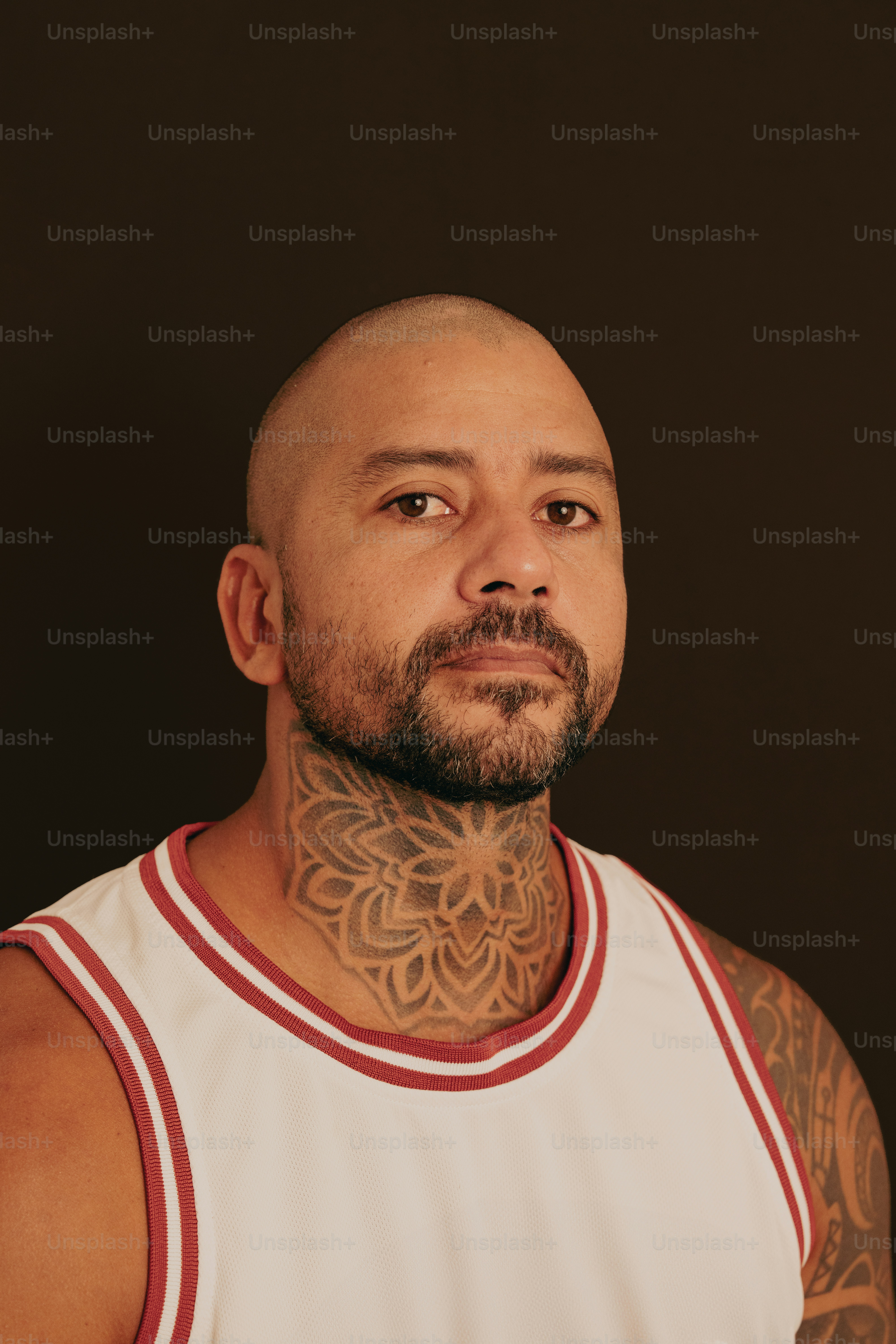 a bald man with a tattoo on his neck