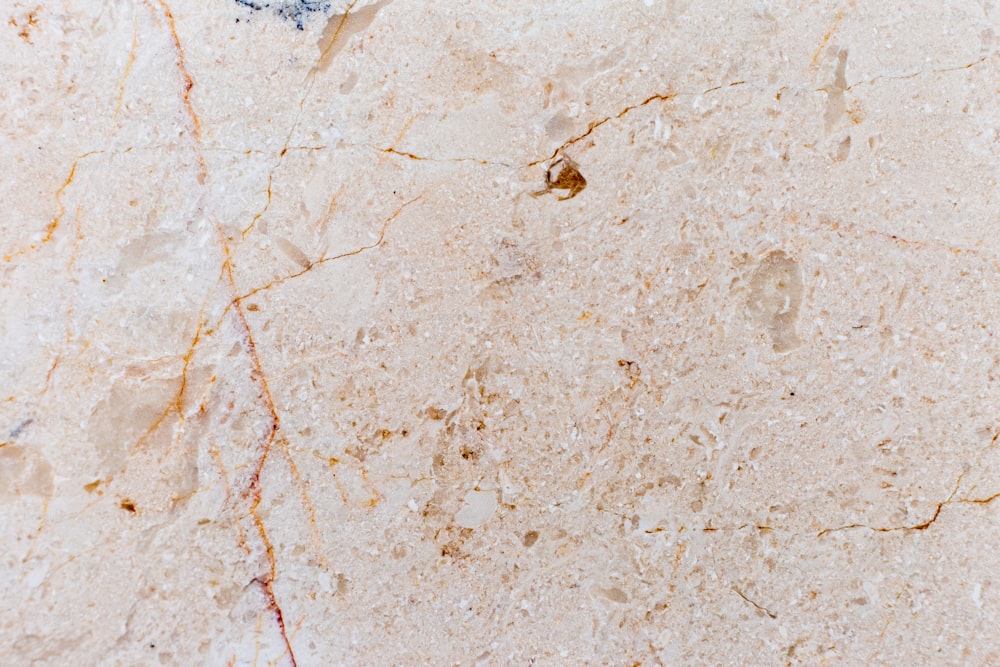 a close up of a marble surface with cracks