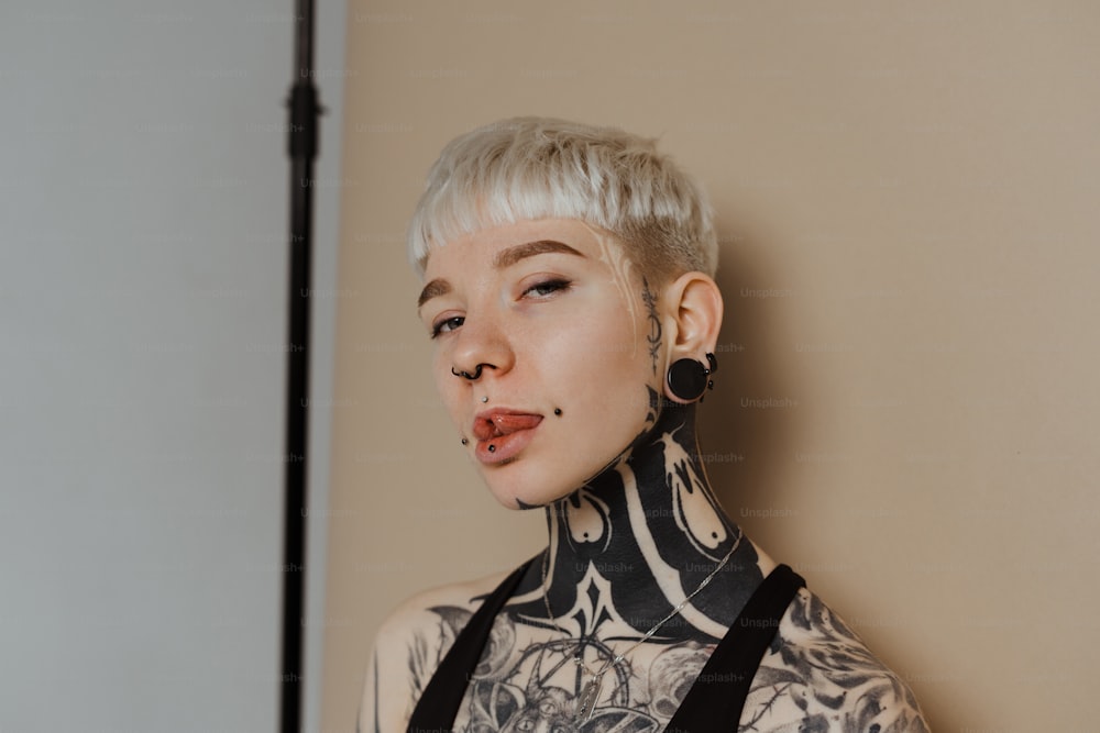 a woman with white hair and tattoos on her body