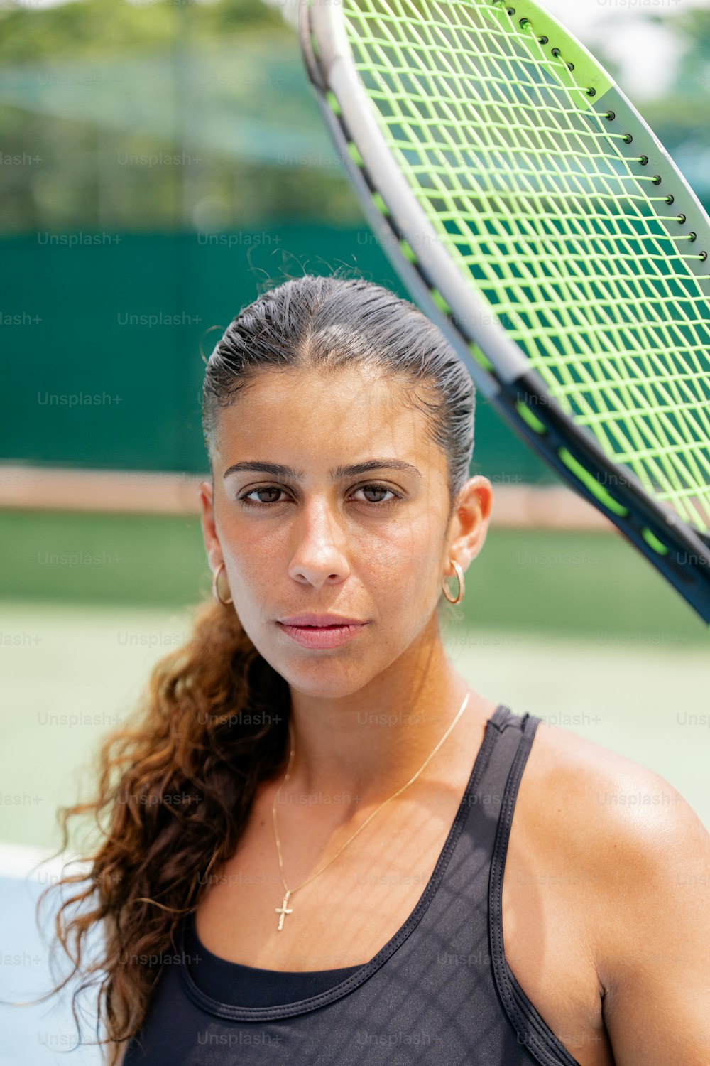 a woman holding a tennis racket on a tennis court