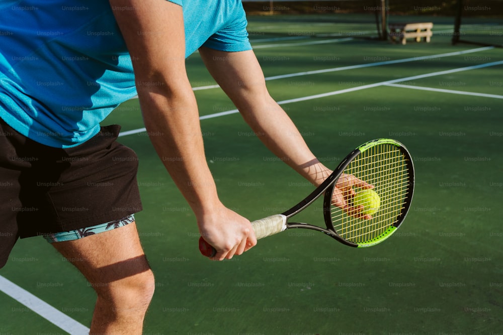 a man holding a tennis racquet on top of a tennis court