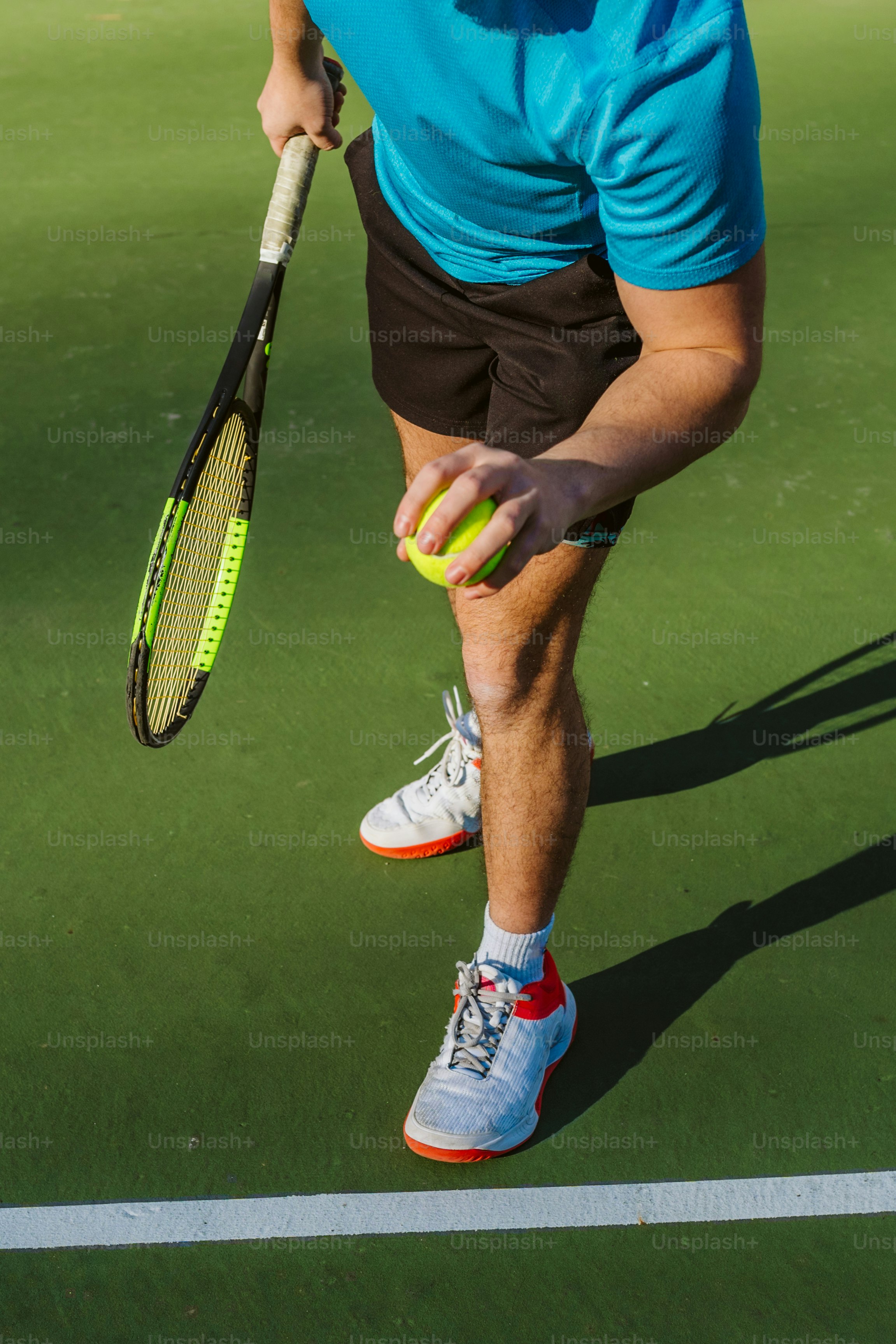 a man holding a tennis racquet on top of a tennis court