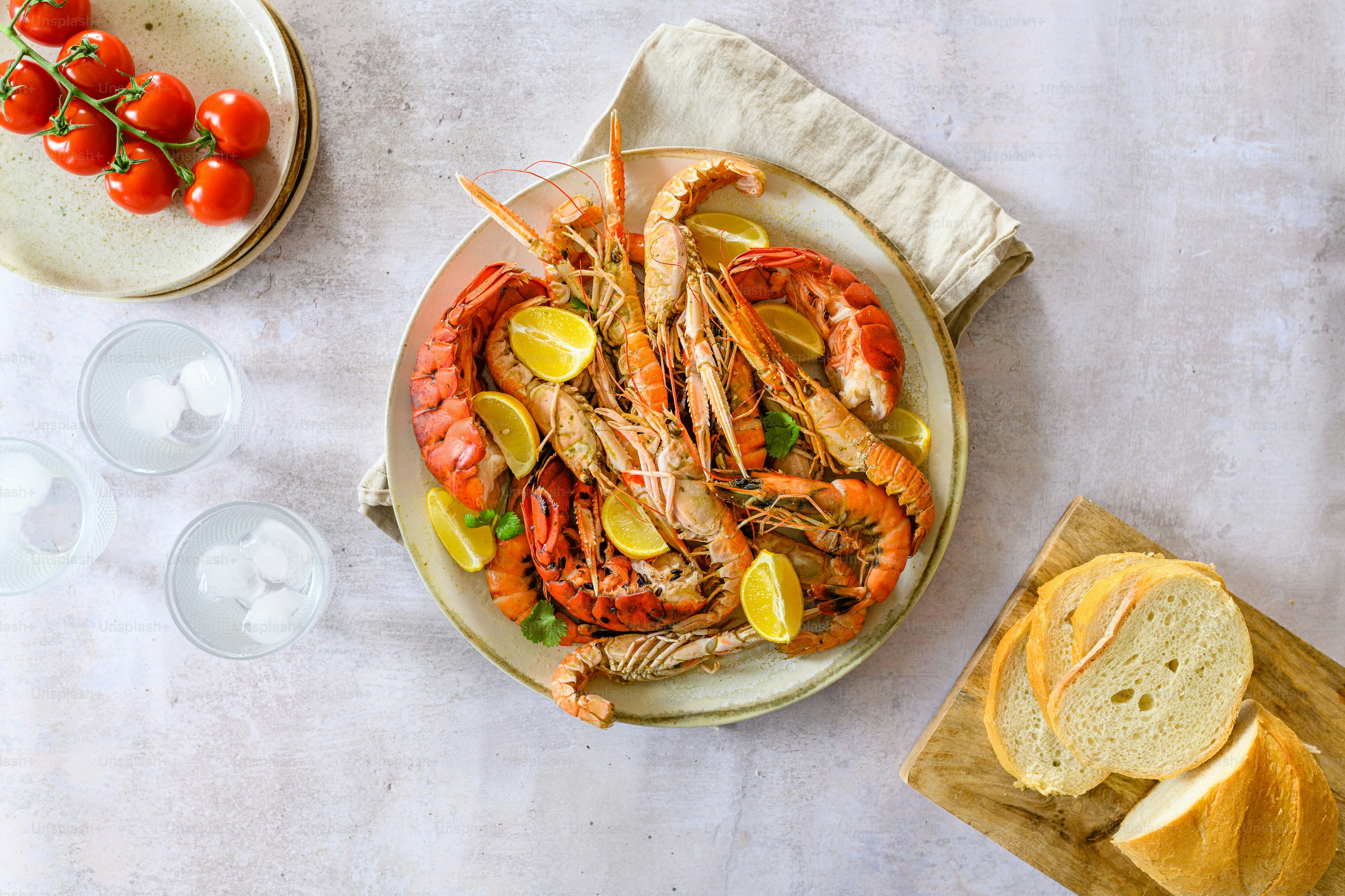 a plate of lobsters and bread on a table