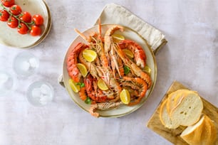 a plate of lobsters and bread on a table