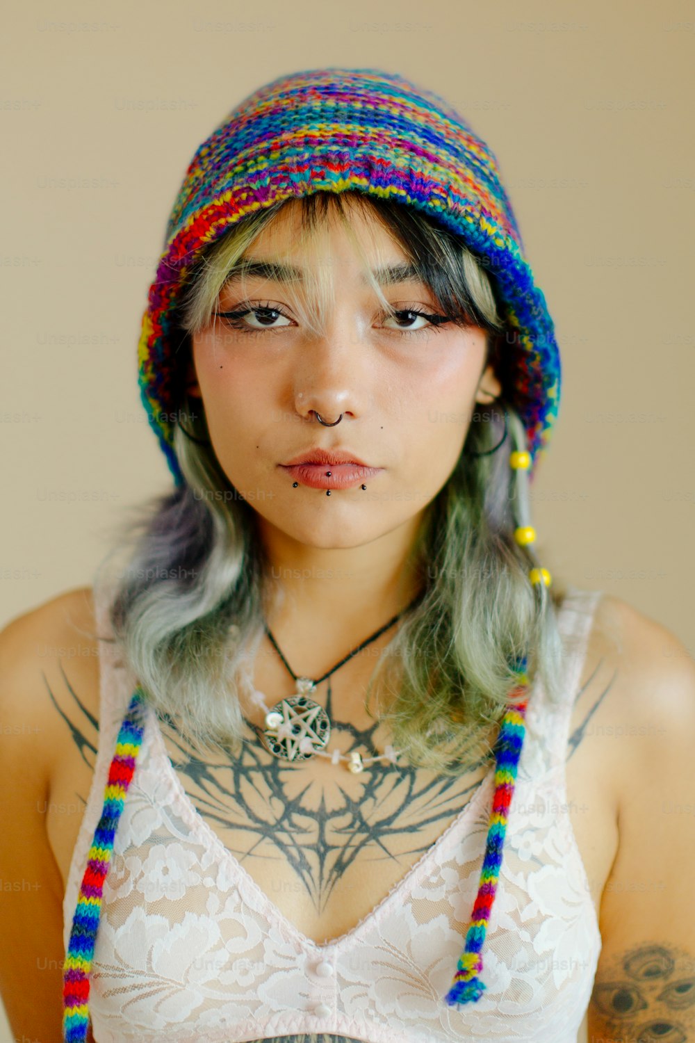 a woman with long hair wearing a colorful hat