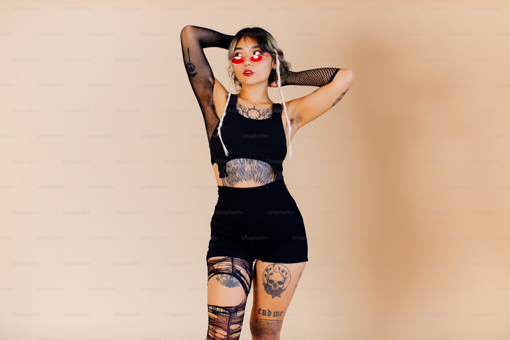 a woman with tattoos on her arms and legs
