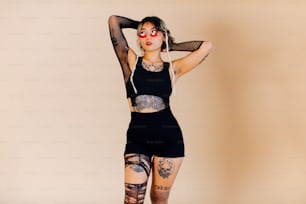 a woman with tattoos on her arms and legs