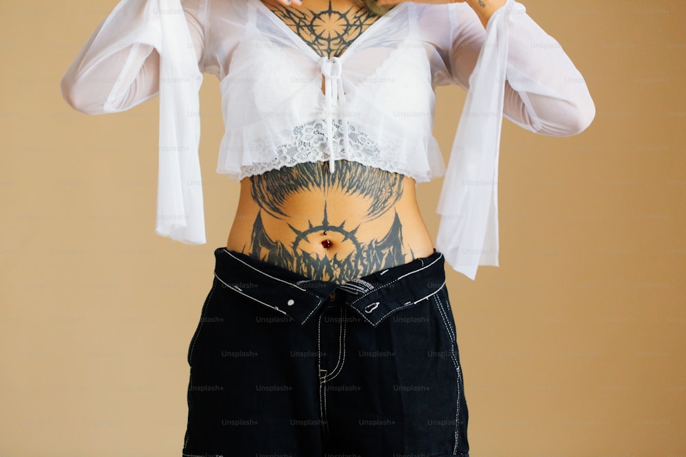 a woman with a tattoo on her stomach
