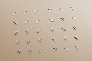 a group of silver crosses on a beige background
