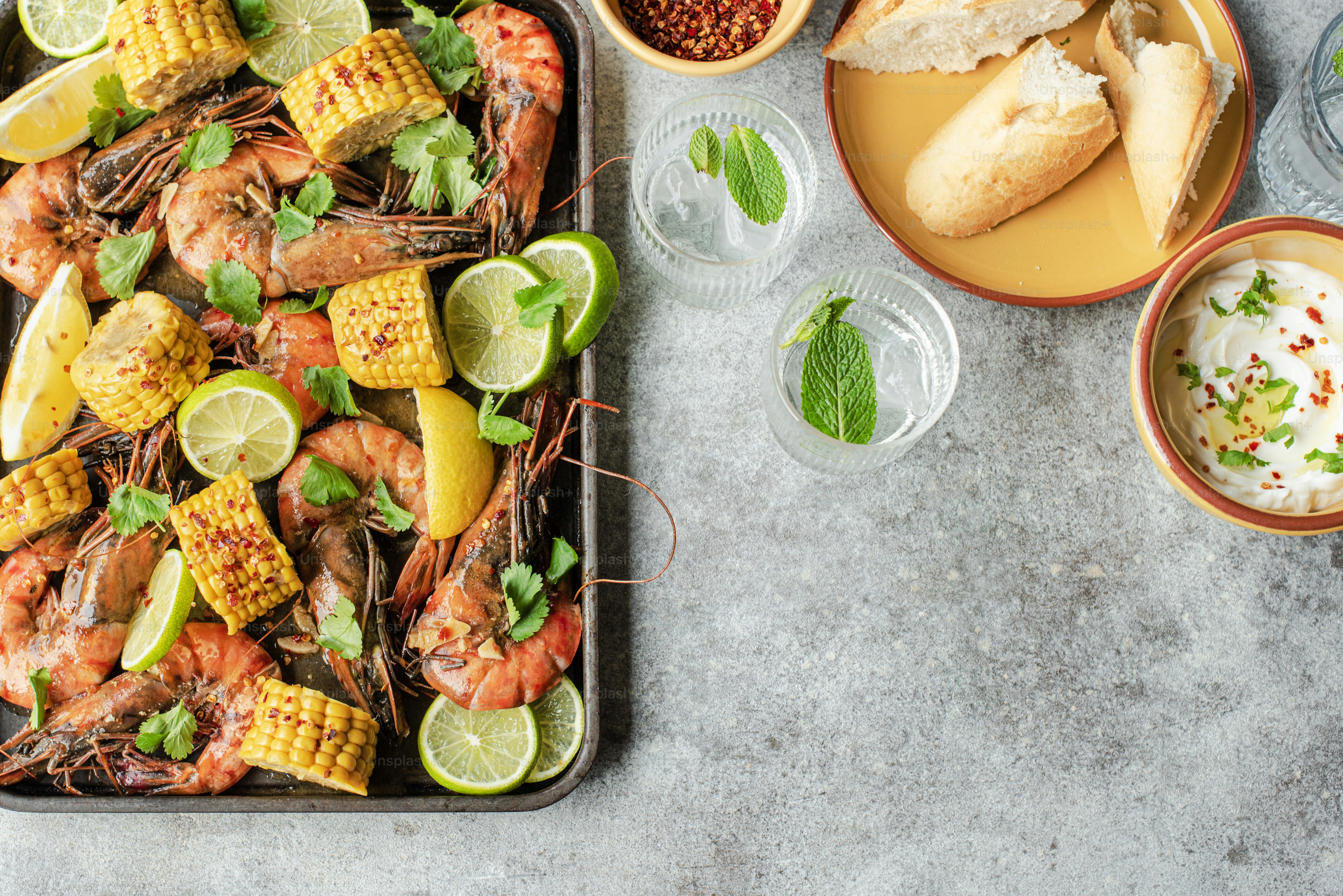 a tray of shrimp, corn, and corn on the cob