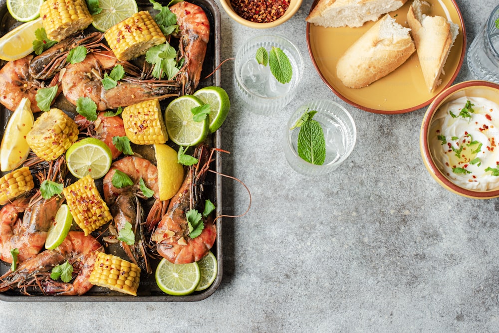 a tray of shrimp, corn, and corn on the cob