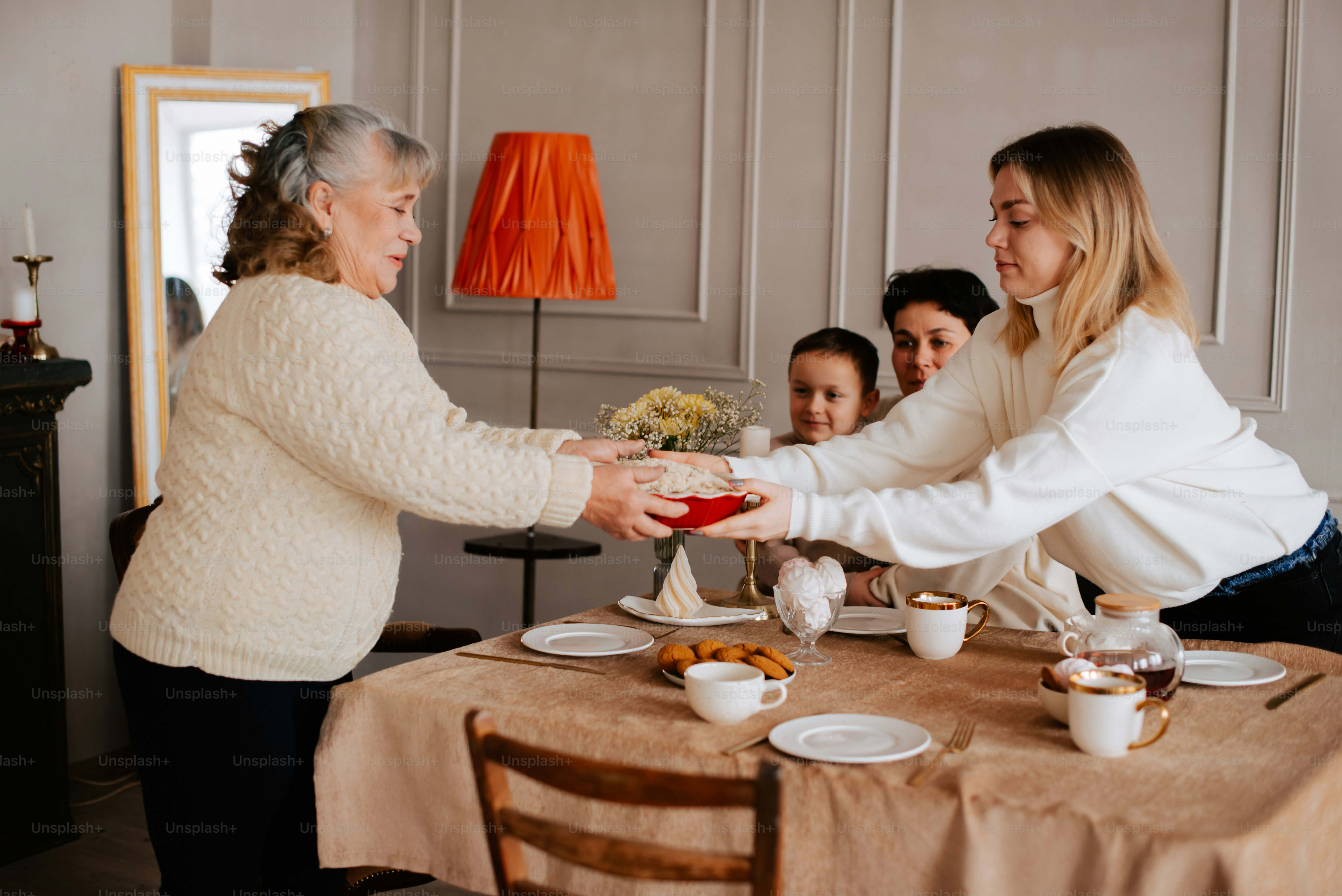 a group of women standing around a table