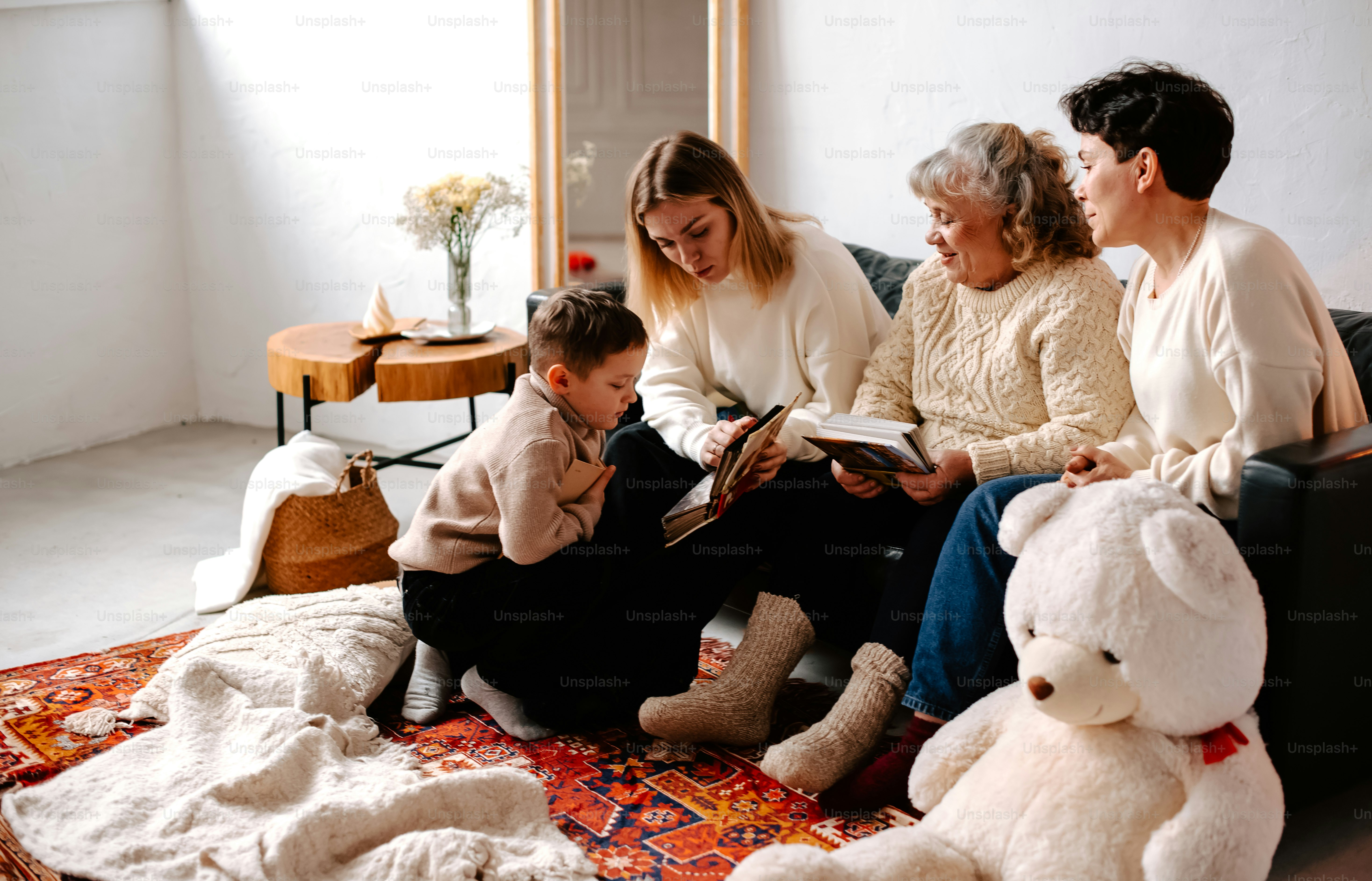 a family sitting on a couch reading a book