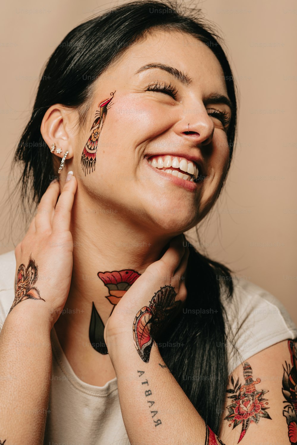 a woman with tattoos on her face smiling