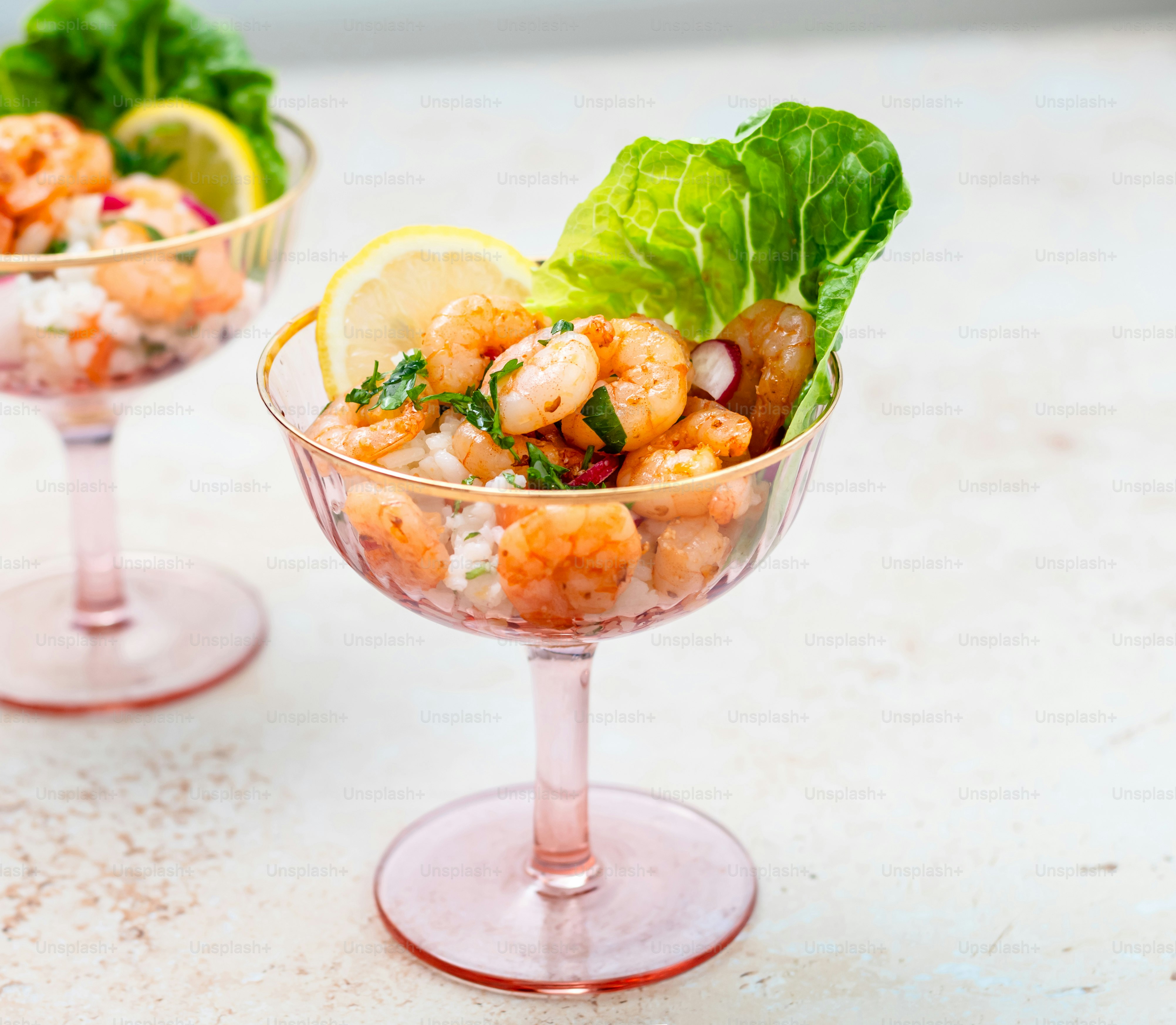 a couple of glasses filled with food on top of a table