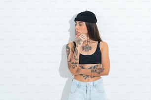 a woman with tattoos and a black hat