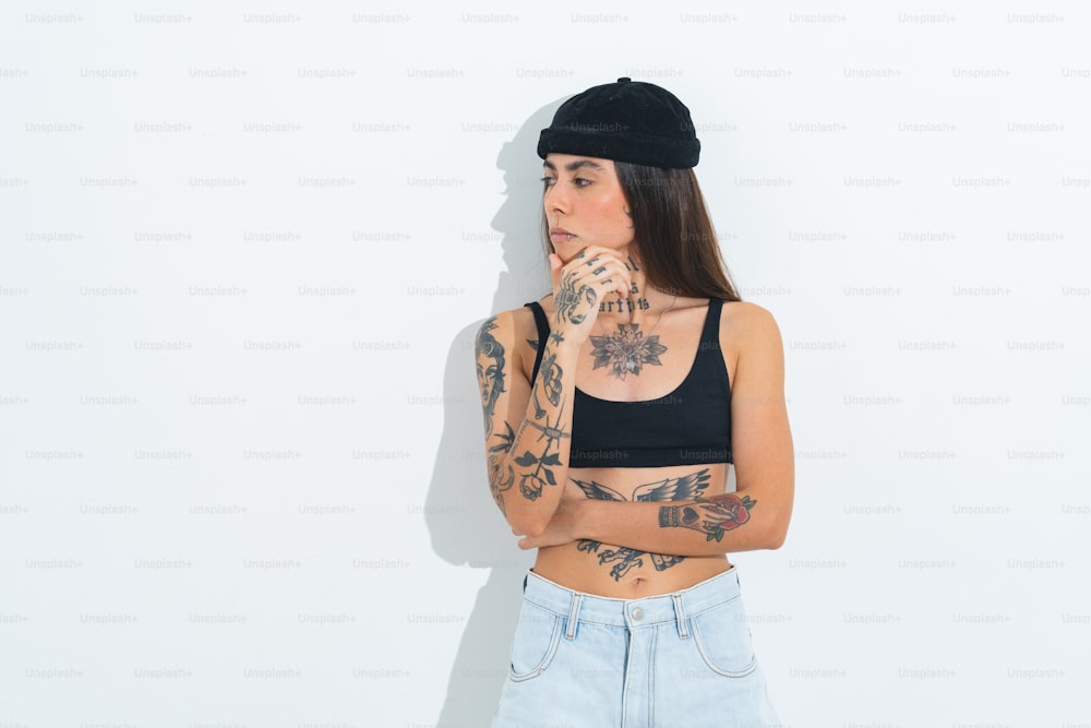 a woman with tattoos and a black hat