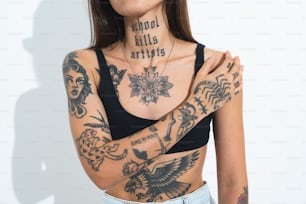 a woman with tattoos on her chest and arms