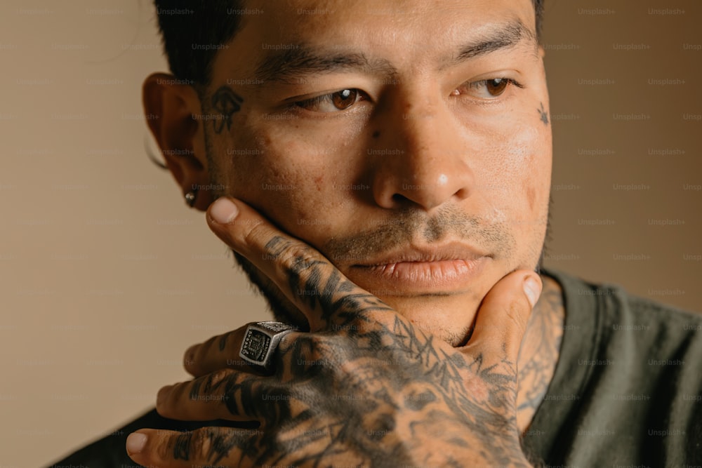 a close up of a person with tattoos on his arms