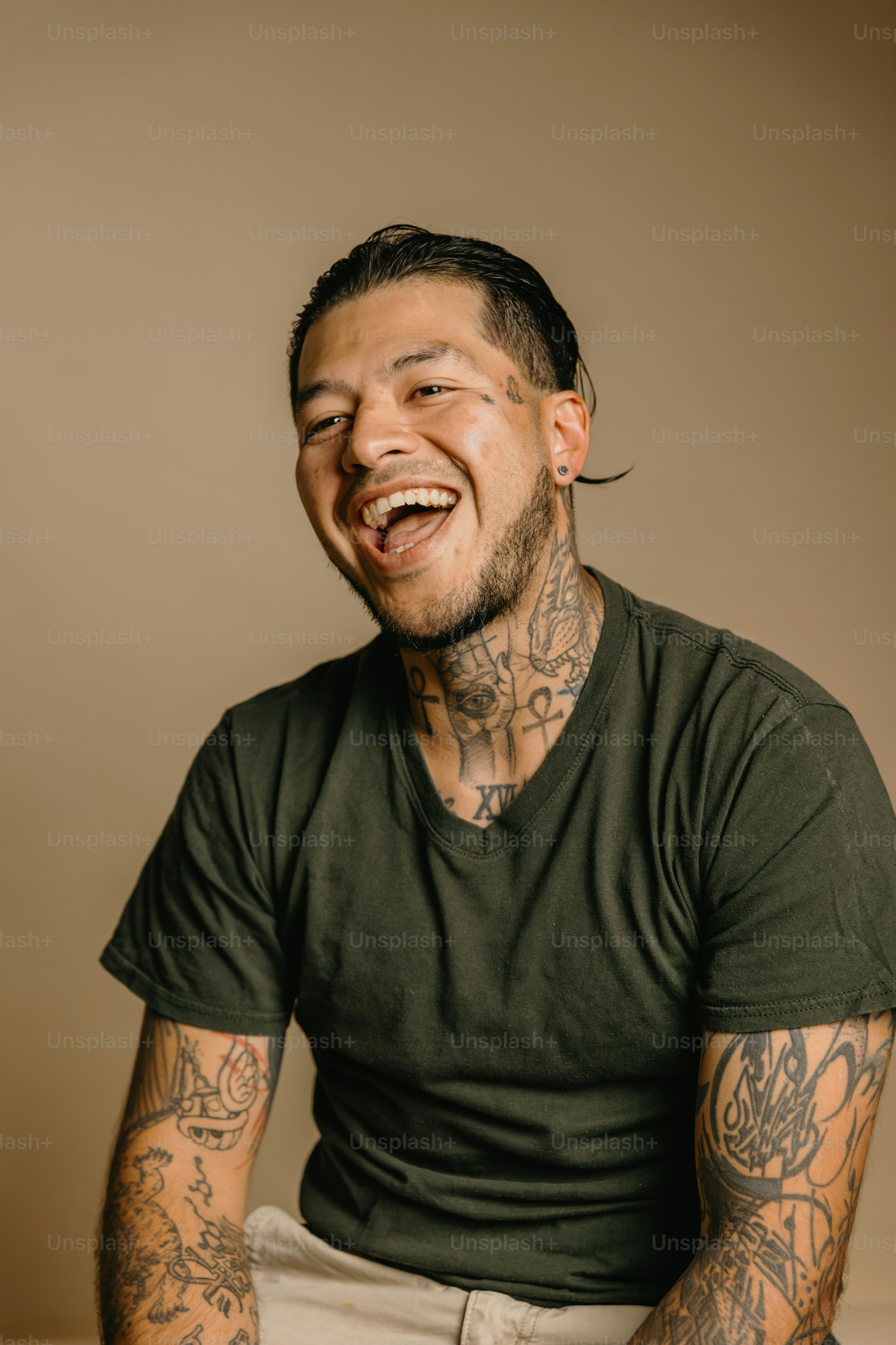 a man with tattoos sitting on a table