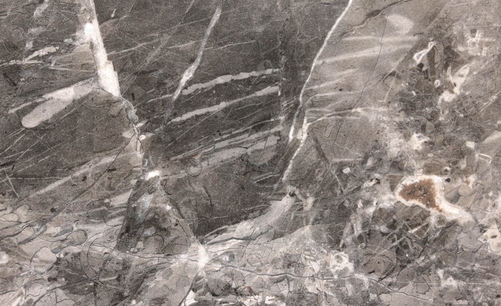 a black and white photo of a marble wall