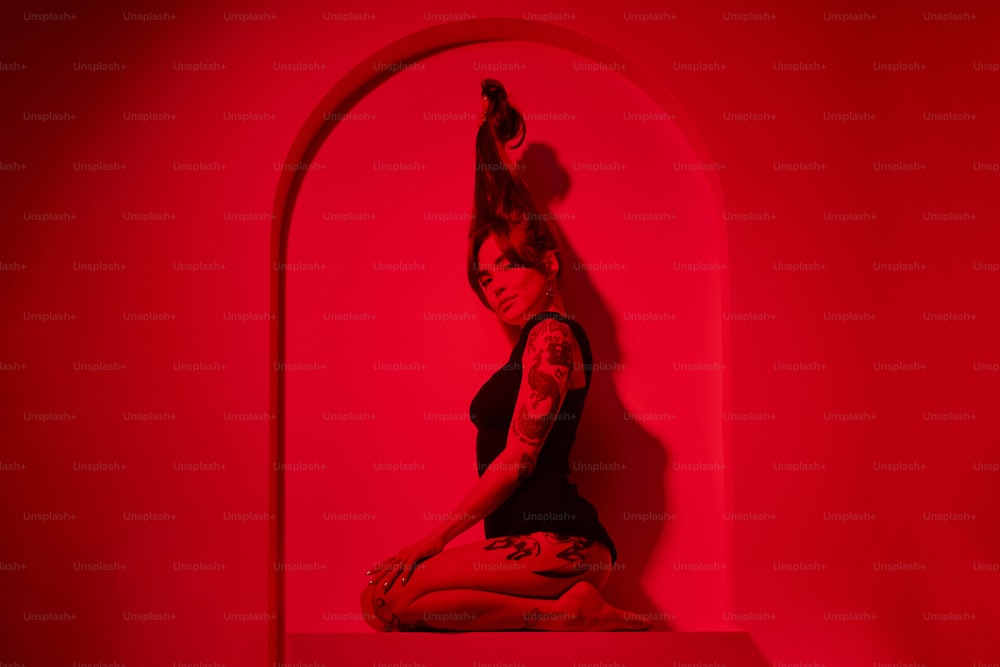 a woman sitting on a shelf in a red room
