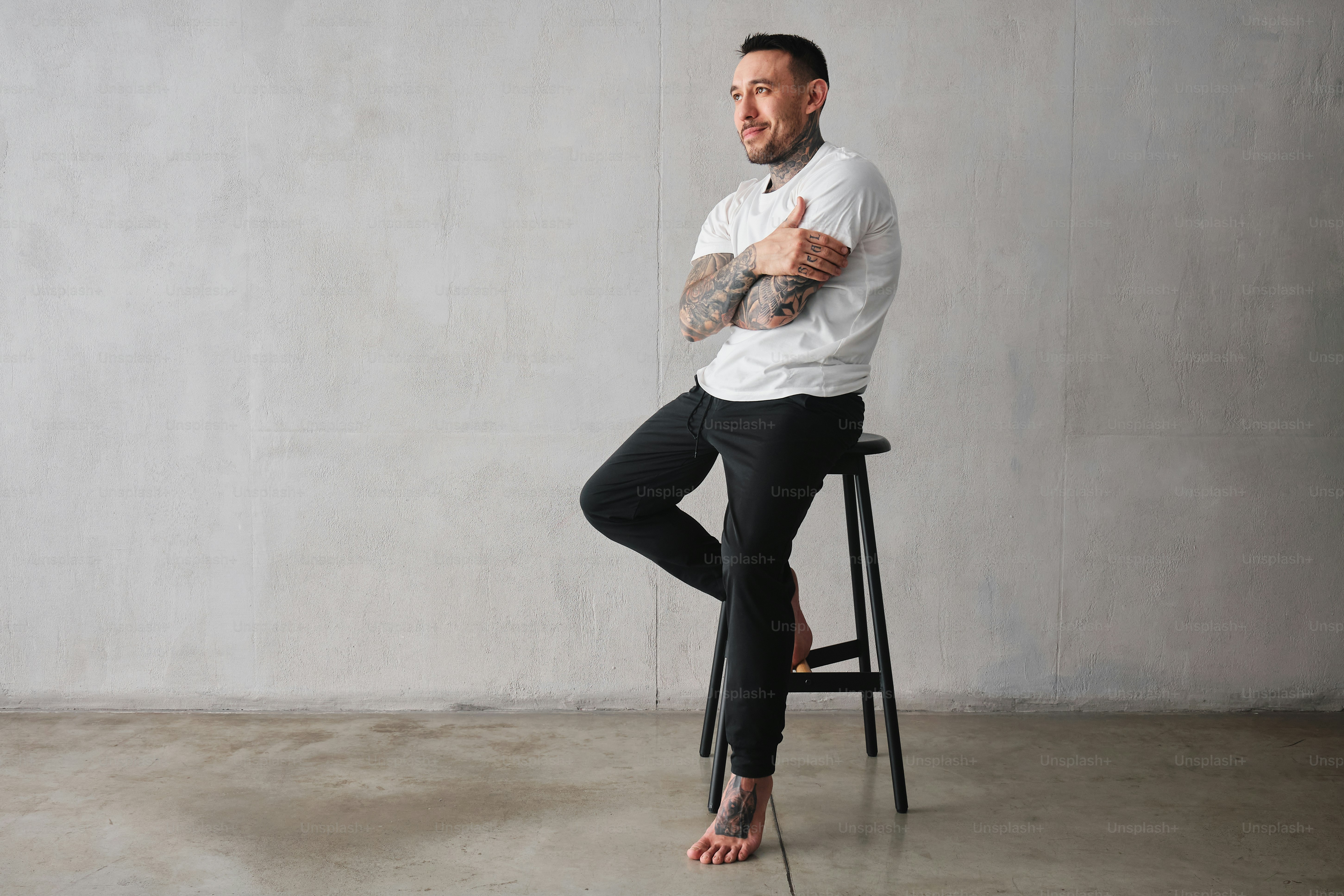 a man sitting on a stool giving a thumbs up