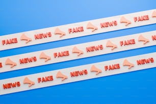 three red fake news stickers on a blue background