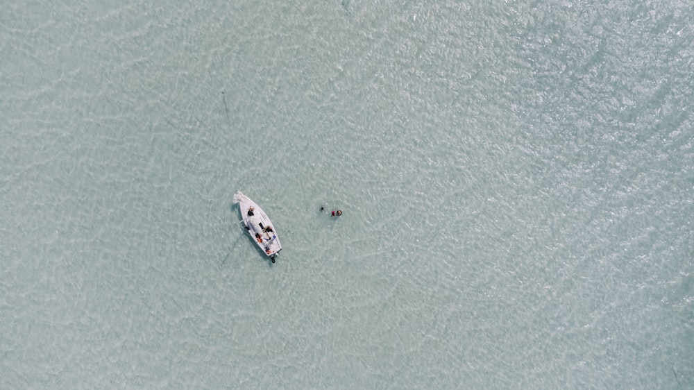 a small boat floating on top of a body of water