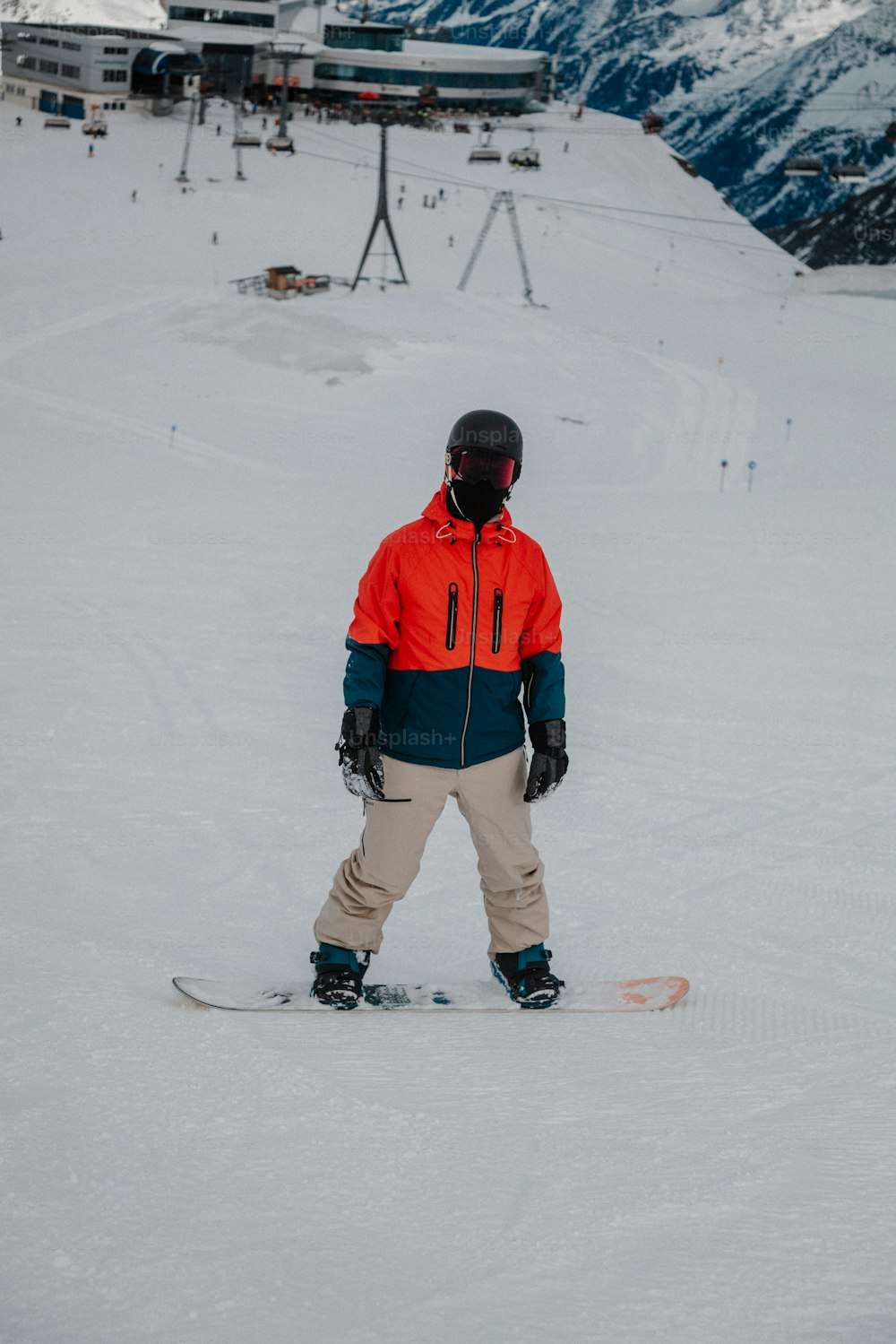 a person standing on a snowboard in the snow