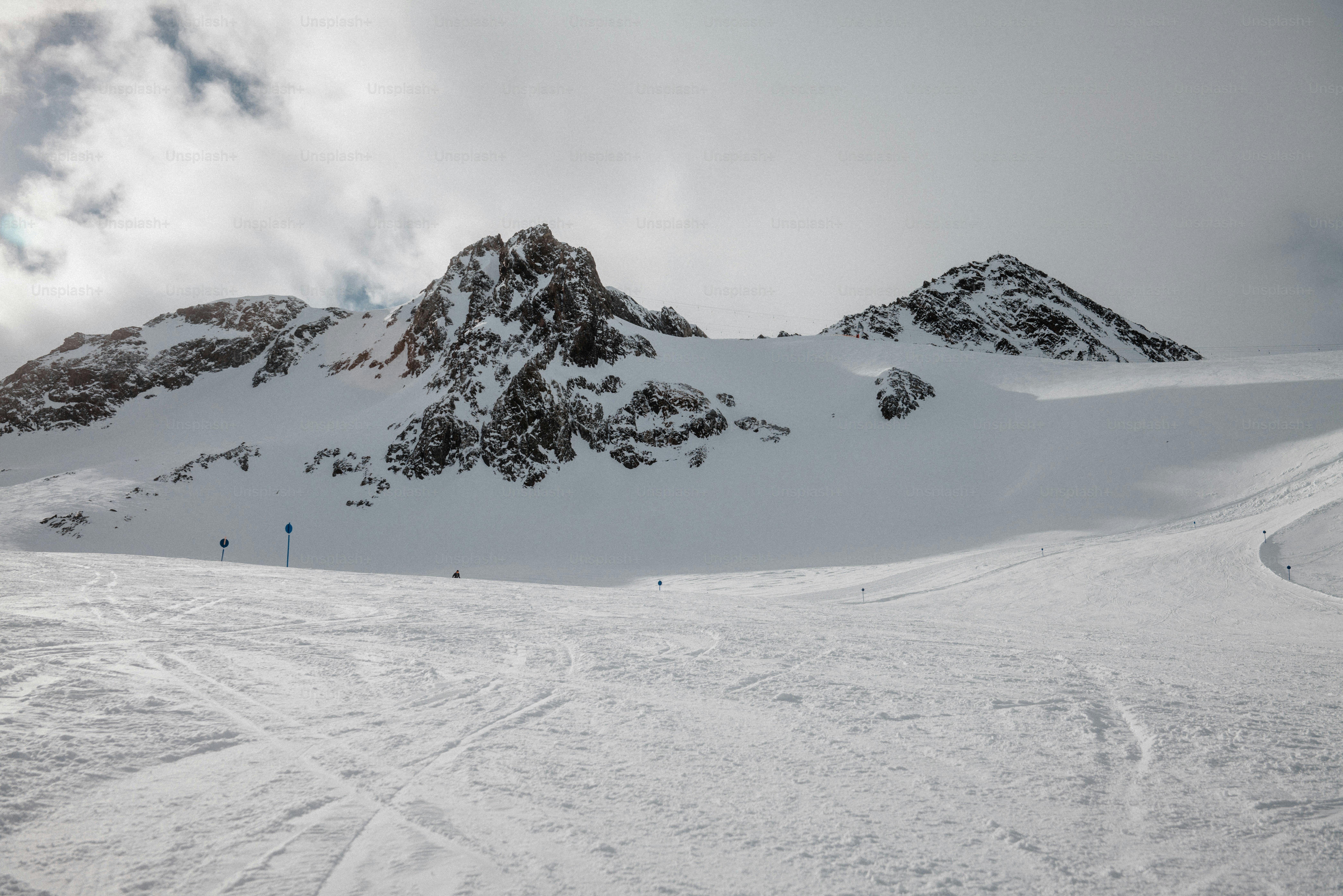 a group of people riding skis down a snow covered slope