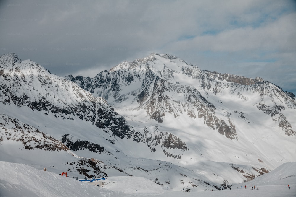 a group of people riding skis on top of a snow covered slope