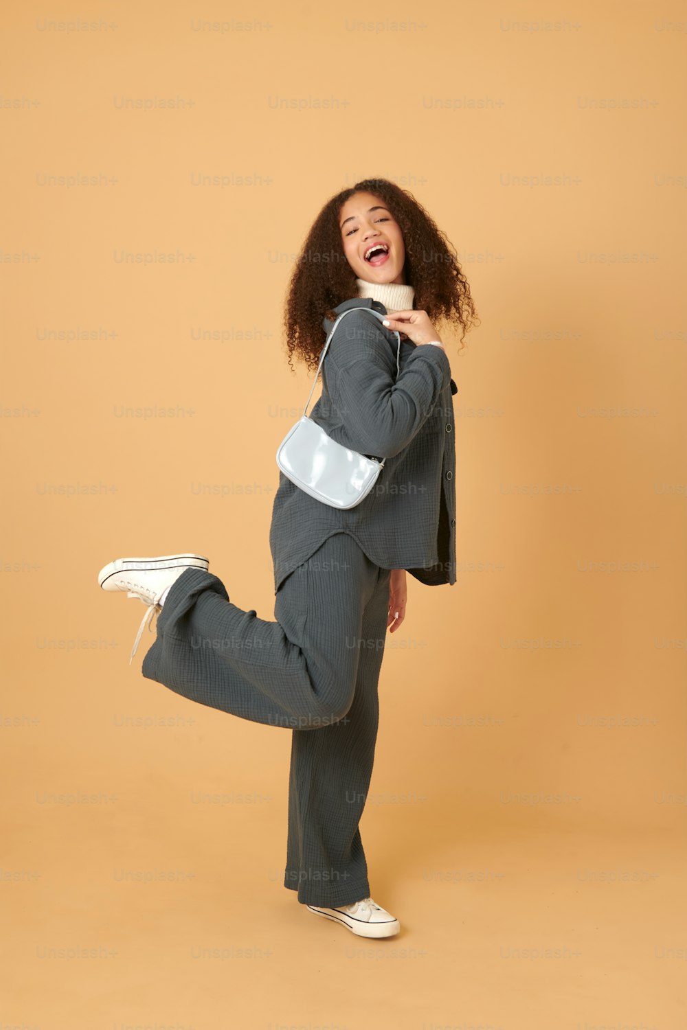 a woman in a suit is posing for a picture