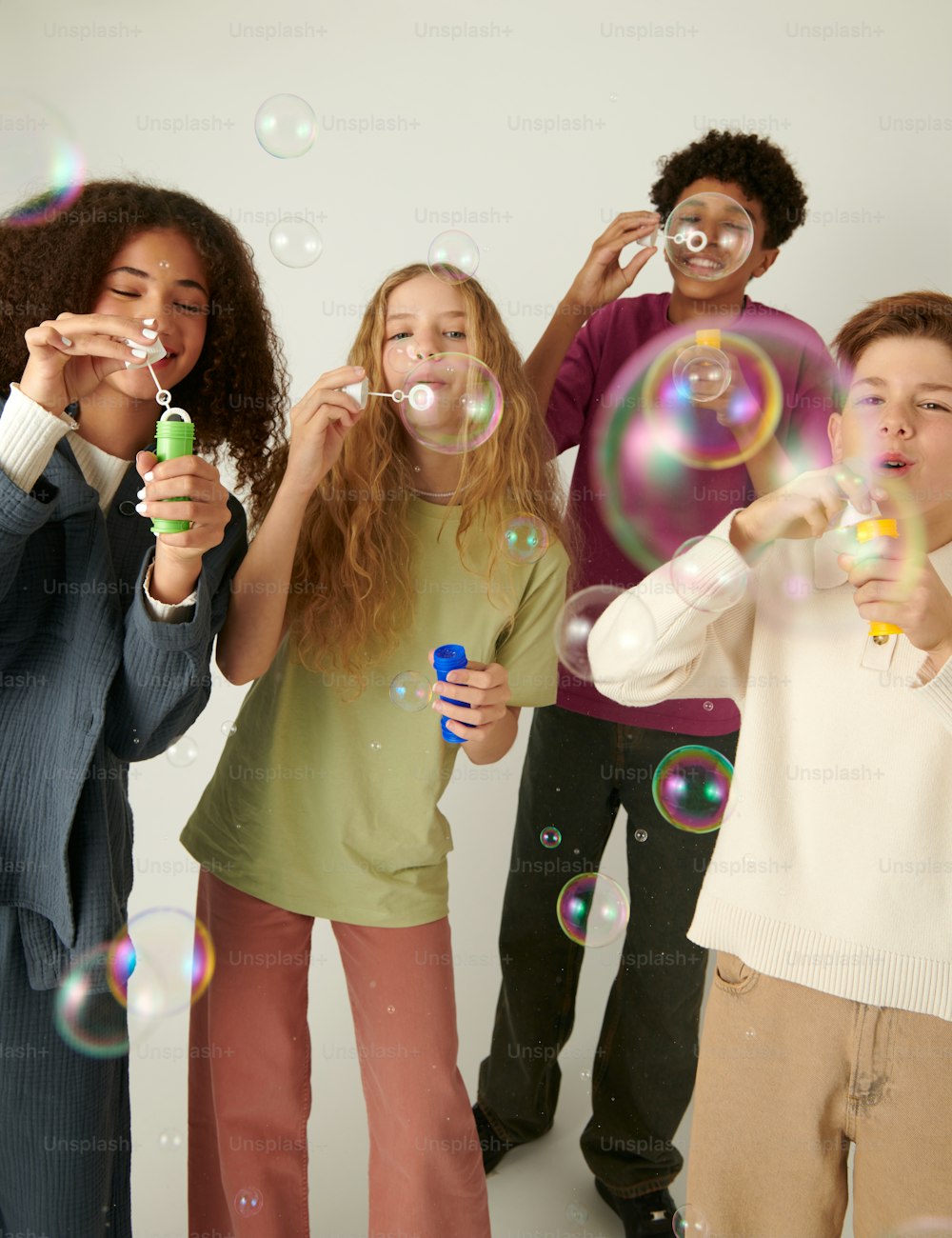 a group of people blowing bubbles in the air
