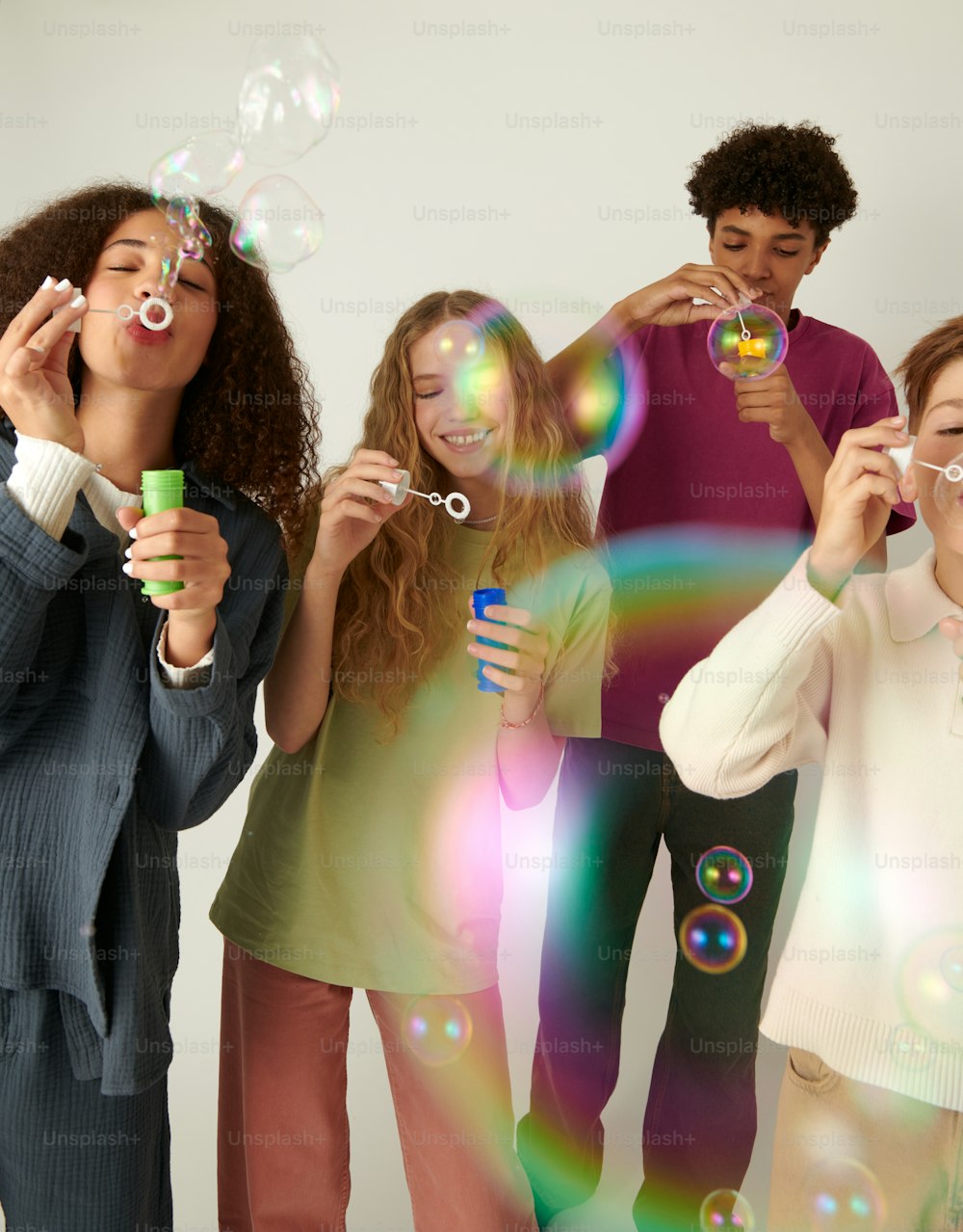 a group of people blowing bubbles in the air