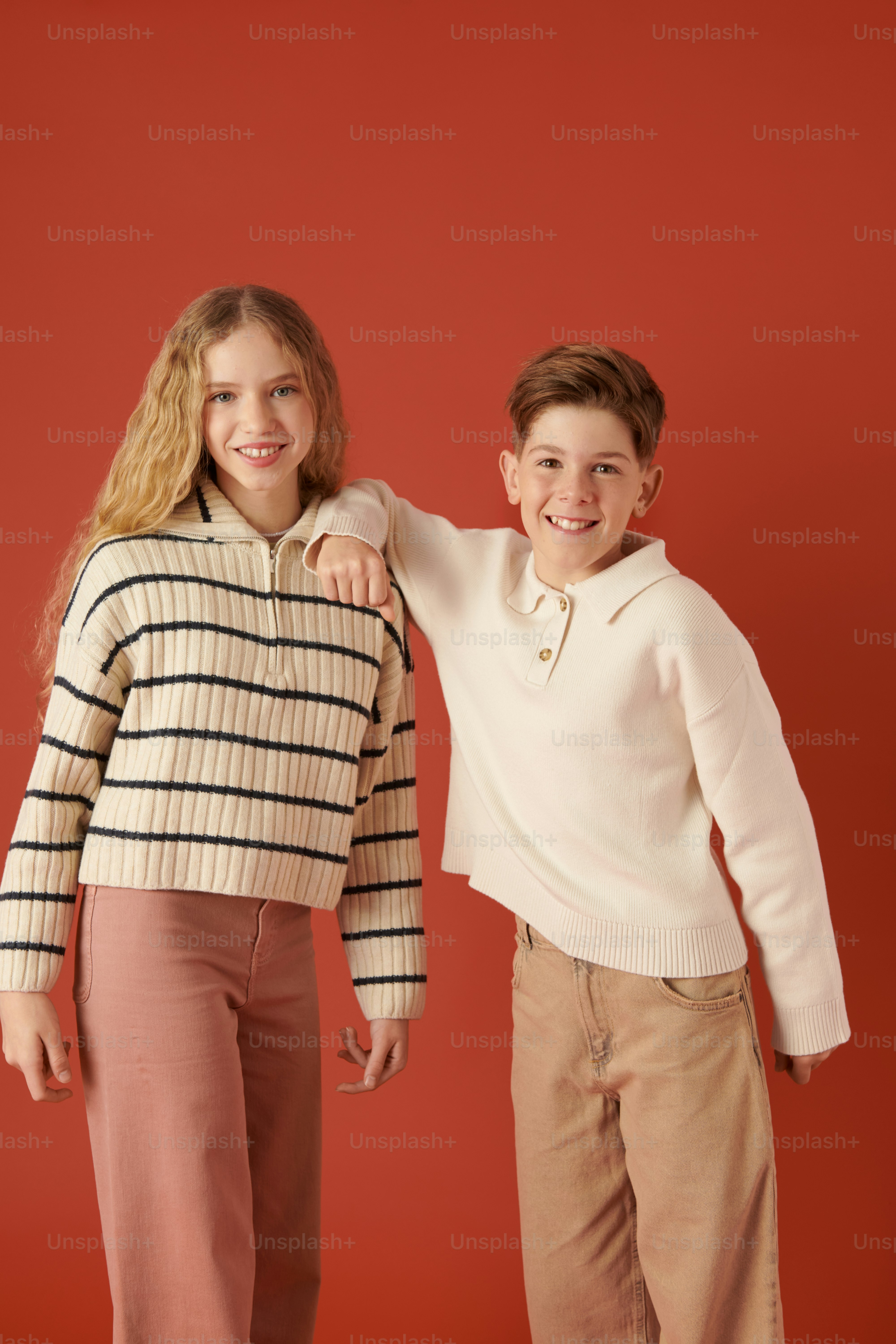 a boy and a girl posing for a picture