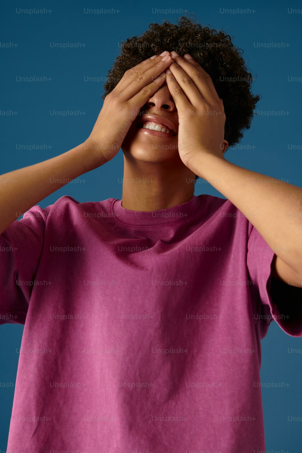 a woman covering her eyes with her hands