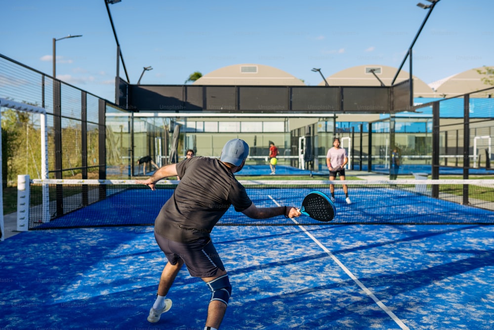 two people playing tennis on a blue court