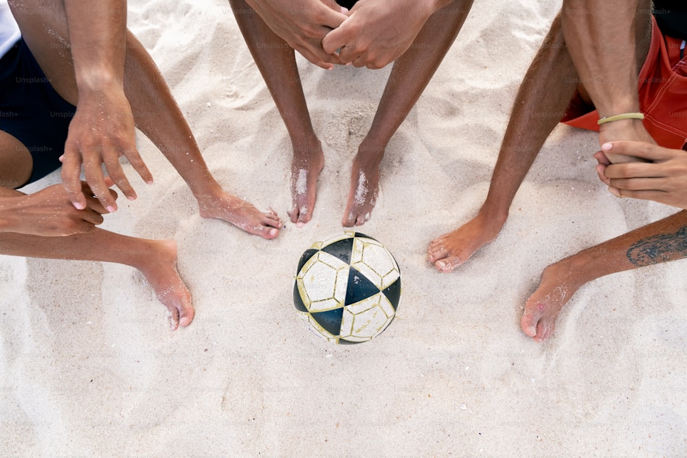 a group of people standing around a soccer ball