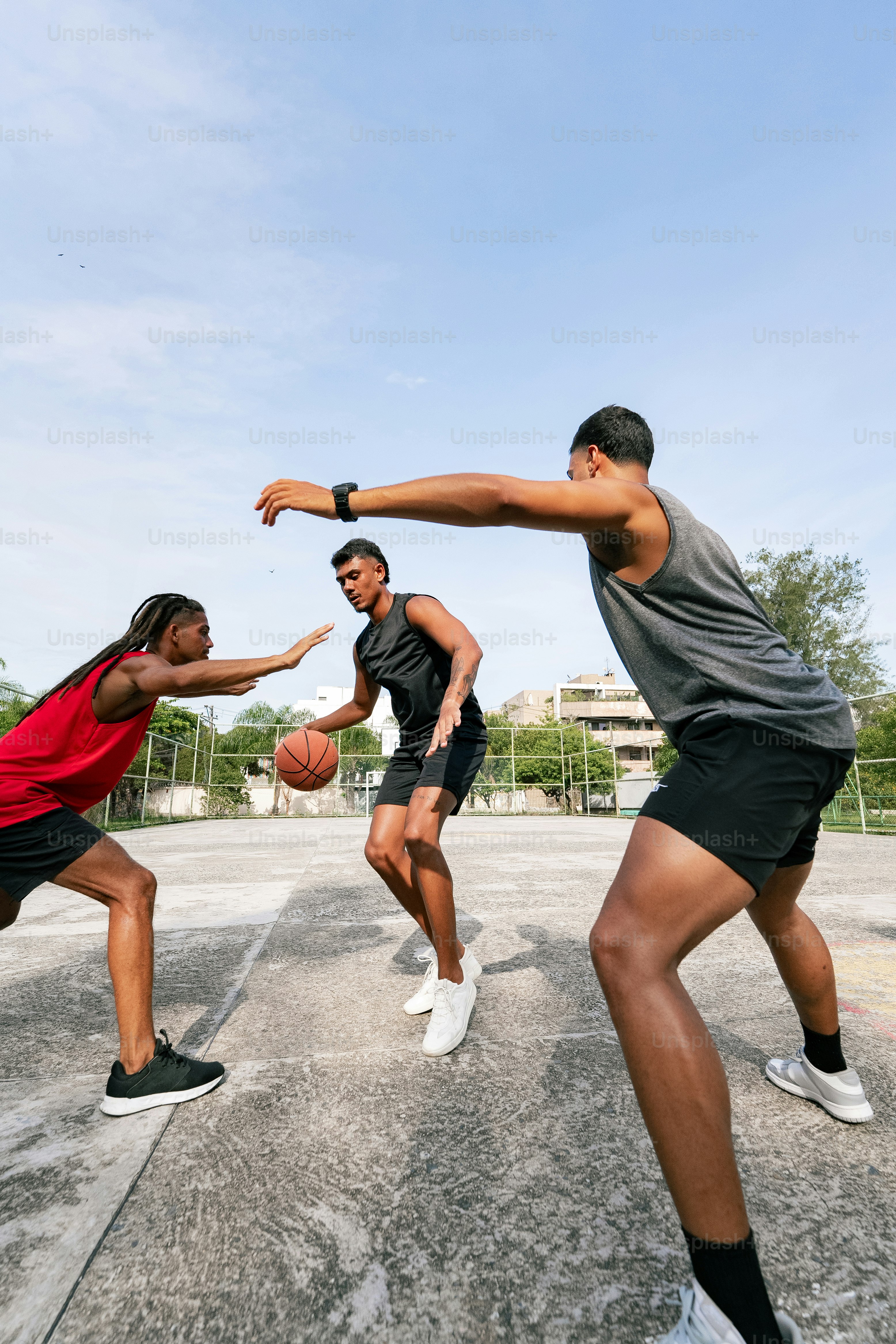 a group of young men playing a game of basketball