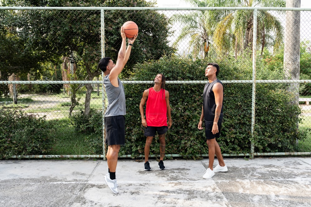 a group of young men playing a game of basketball