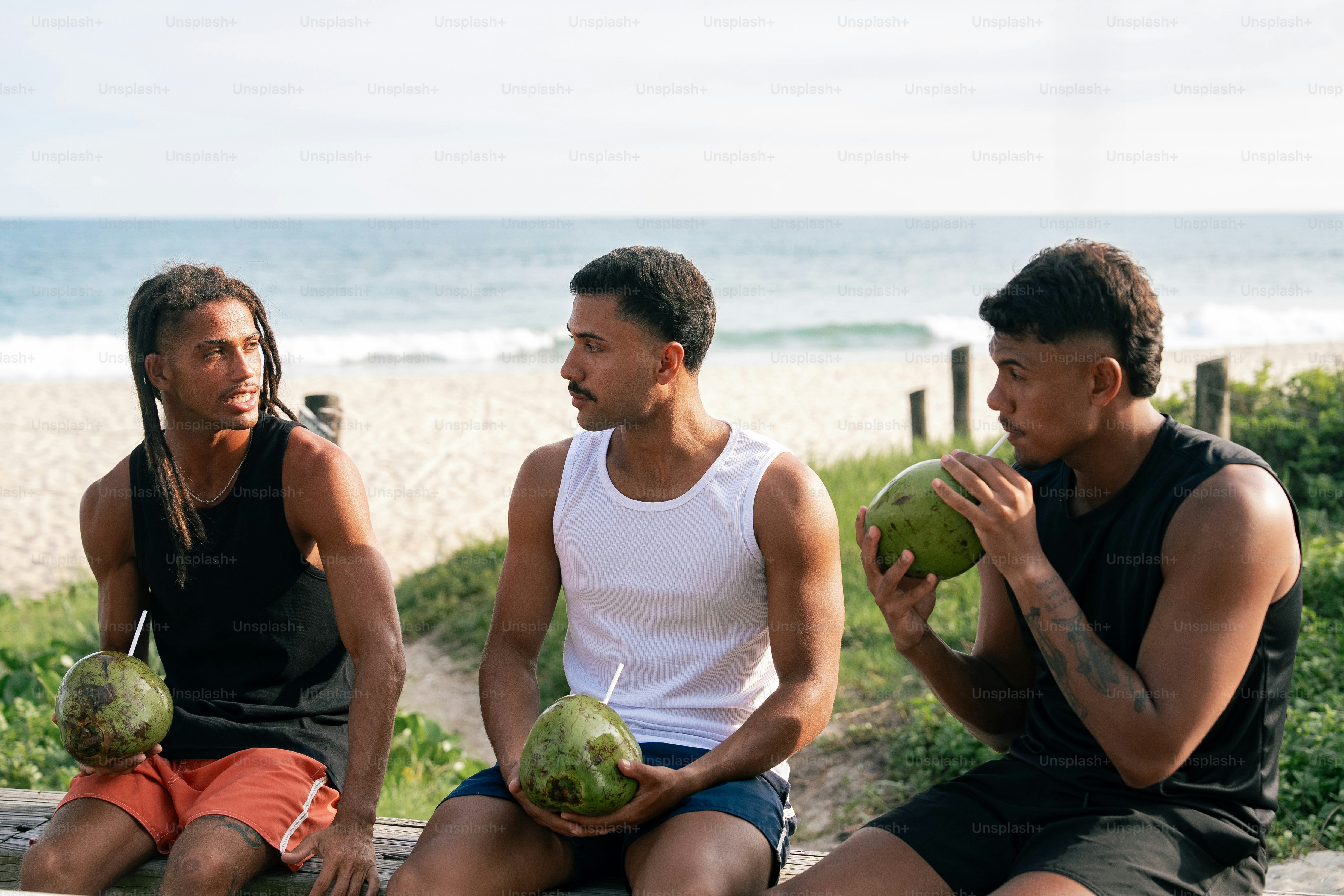 a group of men sitting on a bench next to each other
