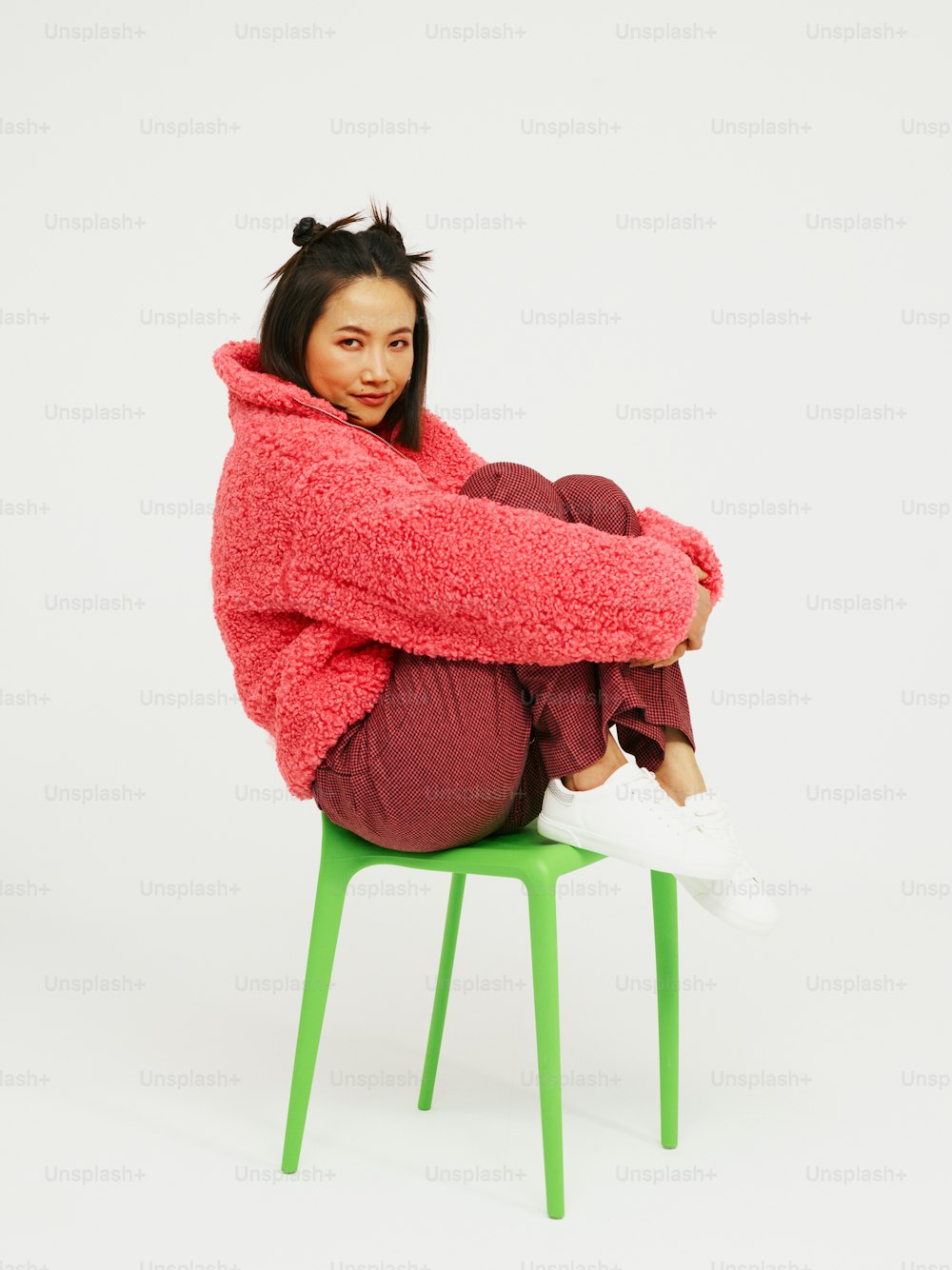 a woman sitting on top of a green chair