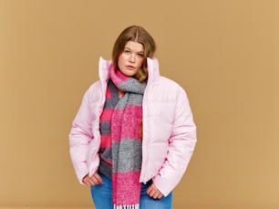 a woman in a pink jacket and scarf