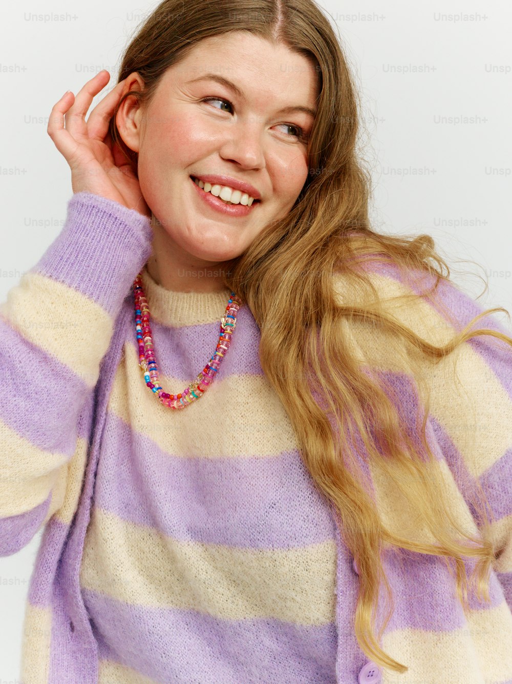 a woman wearing a purple and white striped sweater