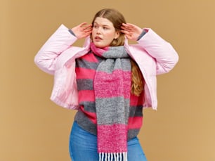 a woman wearing a pink and grey striped scarf
