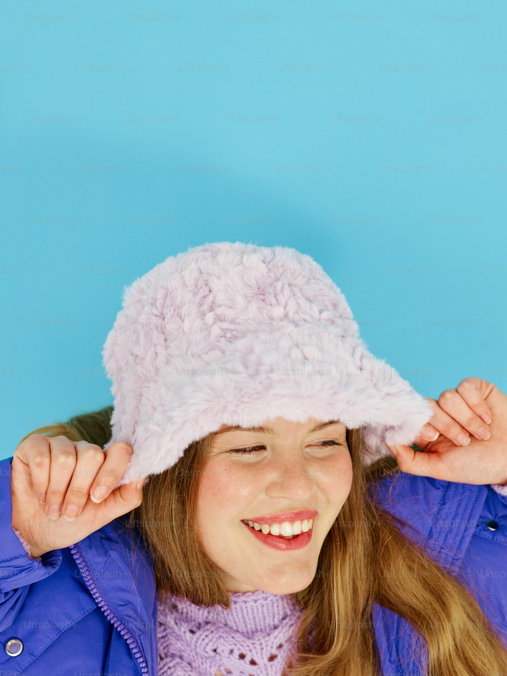 a young girl wearing a pink hat and smiling