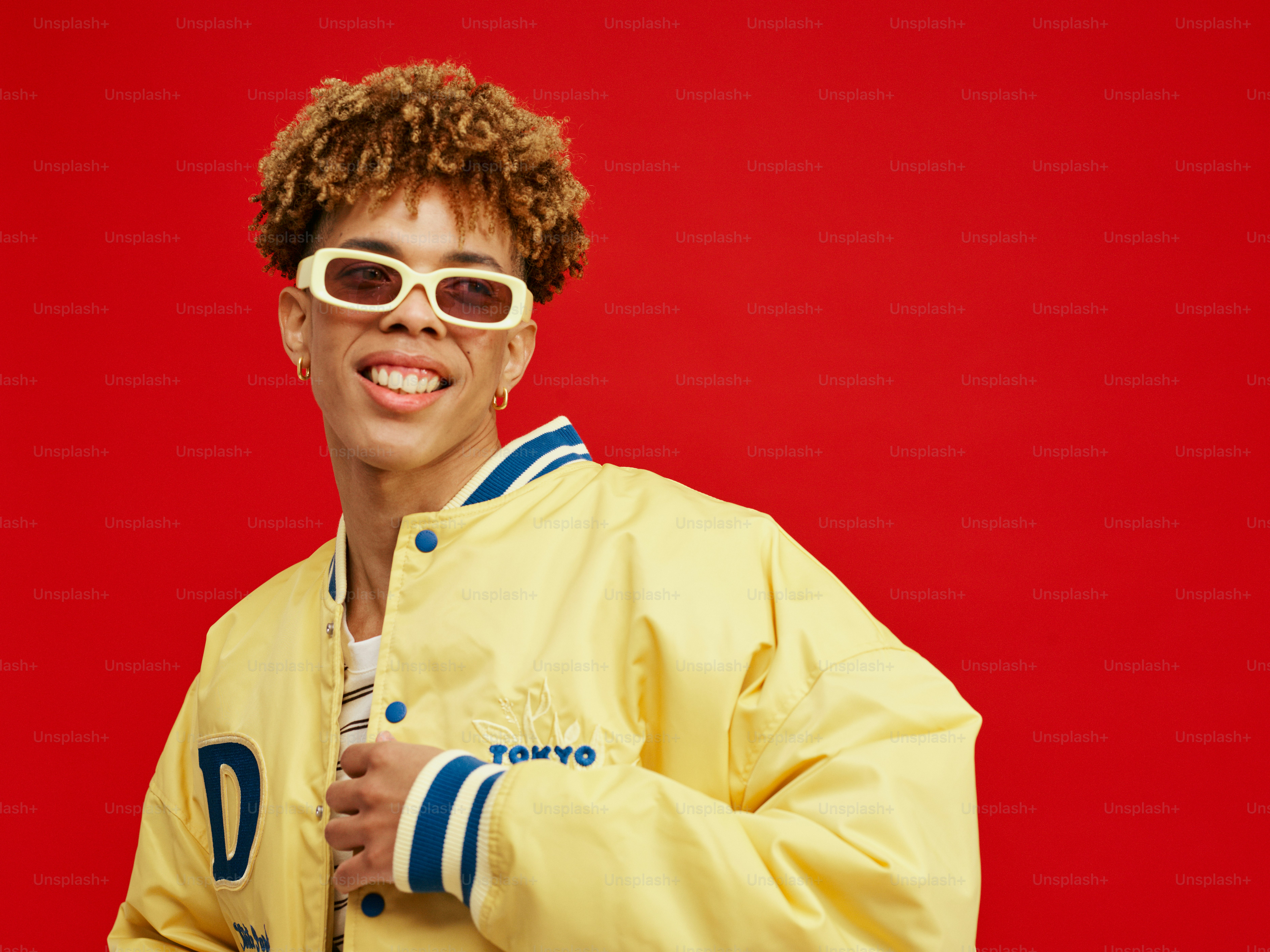 a man in a yellow jacket holding a baseball bat